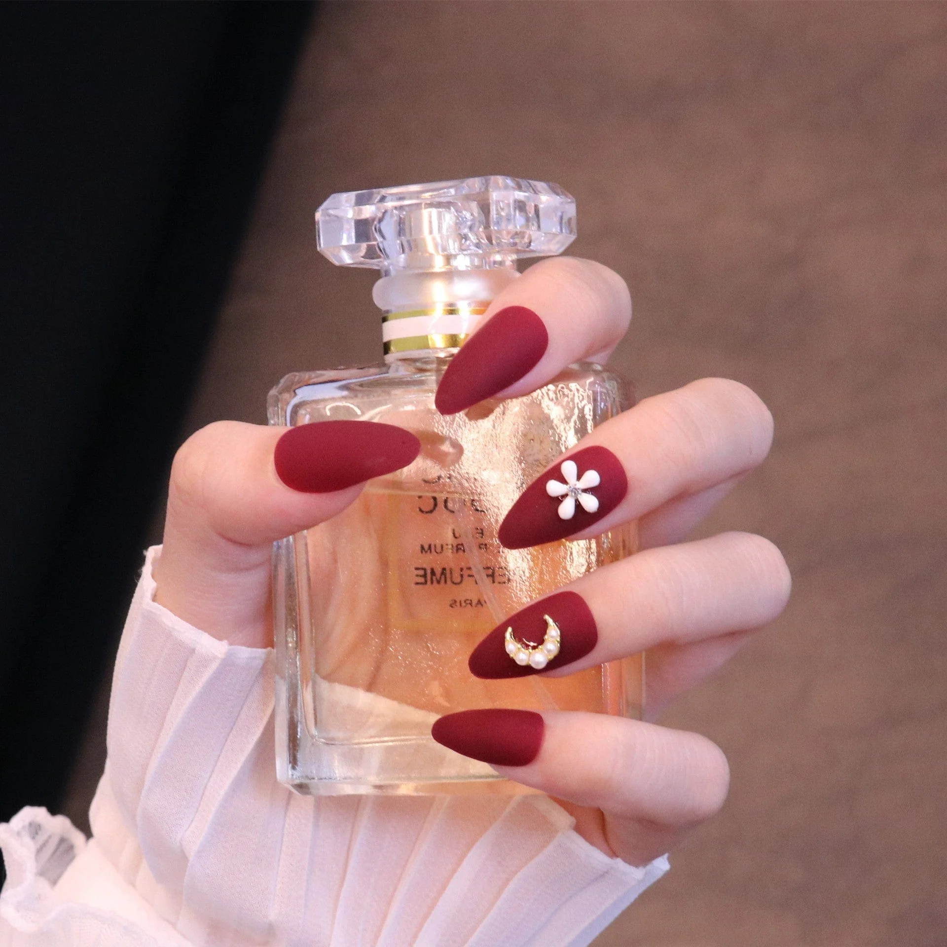 Medium Almond Matte Red Press On Nails with Flower and Moon Charms - Image 4